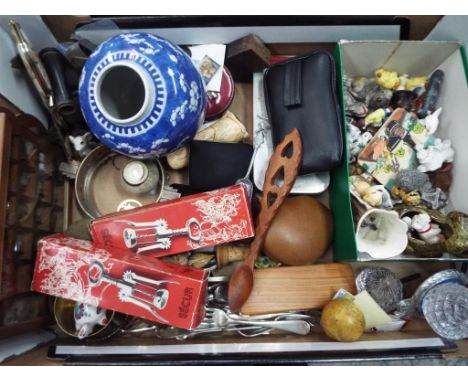 A mixed lot of collectables to include plated flatware, ceramic figurines, thimbles in display case, glassware, vintage car b