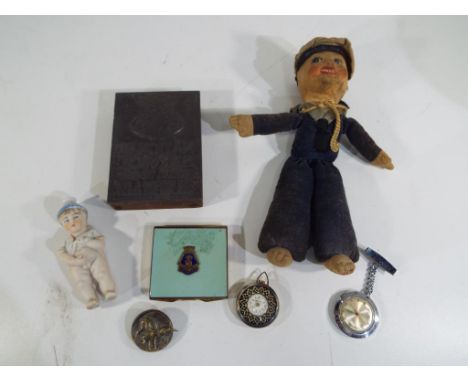 A lead printing block dated 1917, National Service Enrol Today and Relieve a Fit Man for the Front, a 1914 material doll, HMS