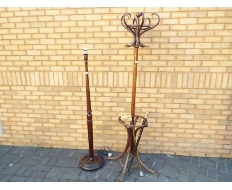 A mid 20th century coat stand, a wooden standard lamp and two walking sticks 