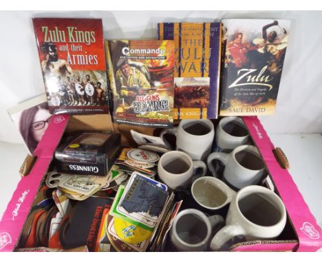 A good mixed lot to include a quantity of vintage collectable beer mats, German stoneware tankards, a Guinness alarm clock an