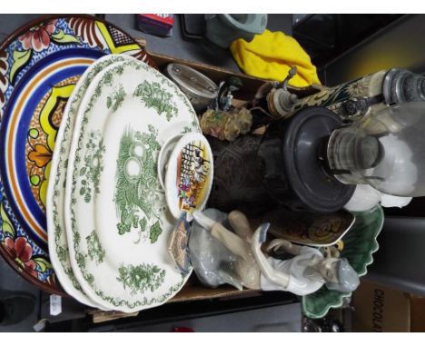 A good mixed lot to include a brass and glass oil lamp, meat plates, German steins and other
