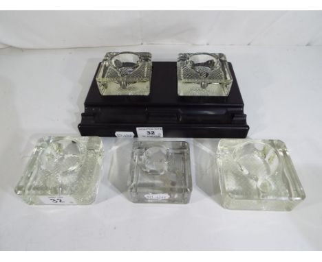 A bakelite inkwell stand with two glass wells, also included in the lot are three additional glass wells. (4). Est £25 - £35