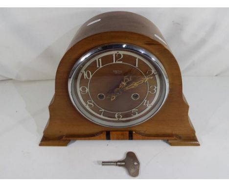 A Smith's mantel clock with key and pendulum, marked  Enfield Made in England to the movement.