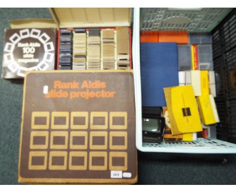 A Rank Aldis slide projector contained in original box, two Halina slide viewers and a quantity of slides (2)