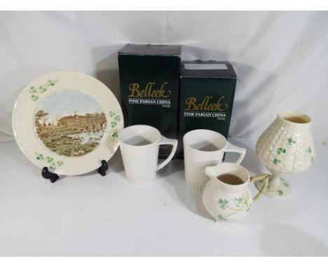 Belleek - Five pieces of Belleek to include a tea light holder and stand (boxed), a pair of mugs, a large plate and a cream j