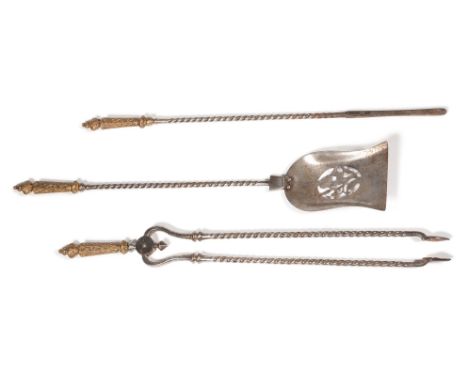 A SET OF THREE STEEL AND BRASS FIRE TOOLS CIRCA 1850 With scrollwork handles and spiral twist stemsthe shovel 81cm long