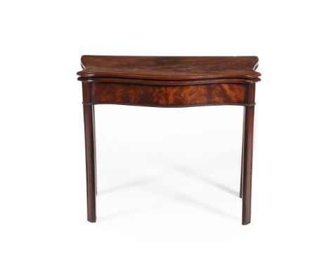 AN EARLY GEORGE III MAHOGANY SERPENTINE FOLDING CARD TABLE IN THE MANNER OF THOMAS CHIPPENDALE, CIRCA 1760 The hinged top ope