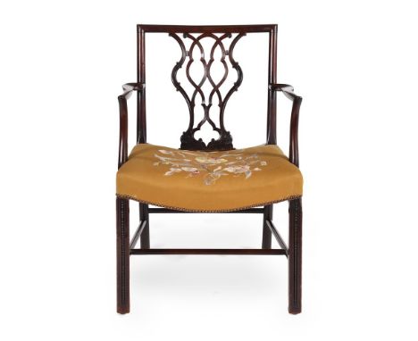 A GEORGE III MAHOGANY AND UPHOLSTERED OPEN ARMCHAIR IN THE MANNER OF THOMAS CHIPPENDALE, CIRCA 1775 Of cockpen type 90cm high