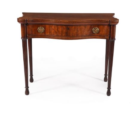 A GEORGE III MAHOGANY SERPENTINE FOLDING CARD TABLE IN THE MANNER OF INCE & MAYHEW, CIRCA 1800 The hinged and shaped top open