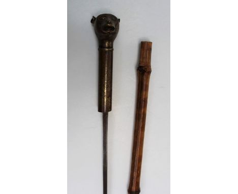 A brass mounted short sword stick, with monkey head handle, diamond section steel blade and bamboo scabbard. Total length 62c