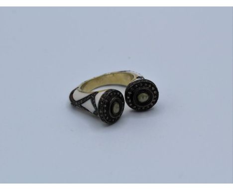 An unusual enamel and diamond gilded ring. Featuring an estimated 1.02ct of rose cut diamonds. Size M.