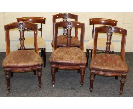 A set of four Edwardian mahogany dining chairs, each with scallop carved and incised rail, pierced vertical splat, button hid