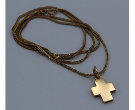 A .585 stamped cross, 3.6 grams approximately, with a 9ct gold chain, 4.2 grams approximately  