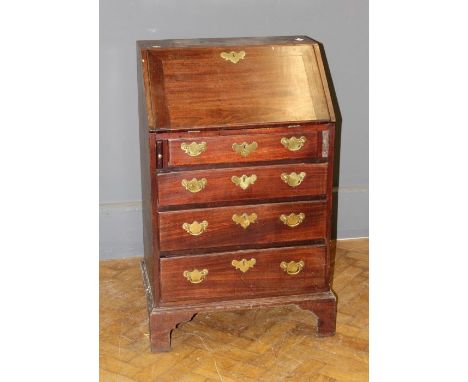 A walnut small bureau, the fall enclosing a stepped fitted interior over four drawers, raised on bracket feet. George III and