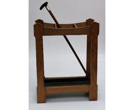 An early 20th century stick stand, together with an Edwardian horn handle walking cane with presentation silver collar, 91cm