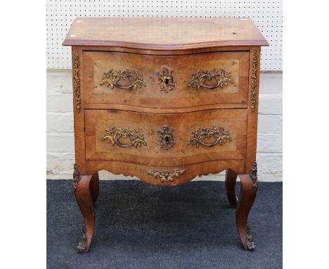 A 19th century French walnut, kingwood crossbanded and gilt metal mounted commode of small size, the serpentine top over two 