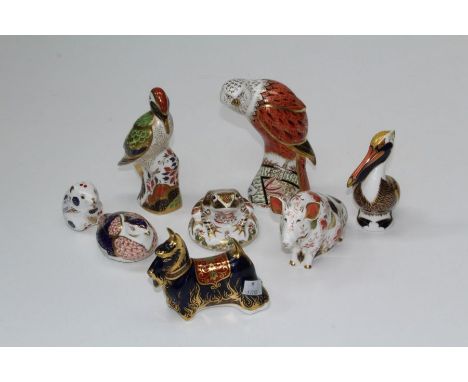 A large Royal Crown Derby Red Kite paperweight, 17.5cm, together with five others including sitting pig, brown pelican, green