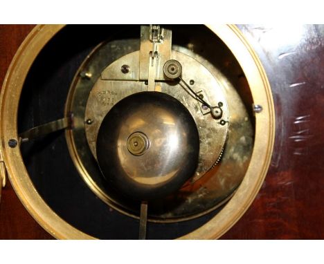 John Walker, London, an Edwardian mahogany, fan inlaid and strung library clock. The lancet form case enclosing an eight day 