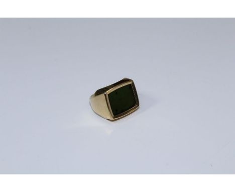 A 9ct gold ring, set with oblong jade panel, to a plain shank. 8gm gross weight, size J