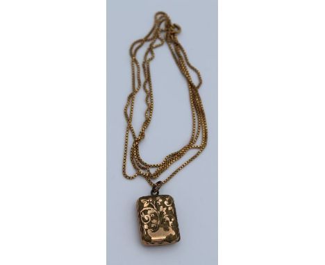 An 18k stamped box chain and unmarked yellow metal mourning locket