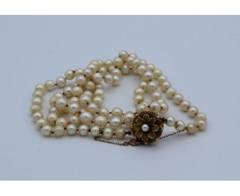 A cultured pearl single strand necklace with 9 carat gold flower form box clamp