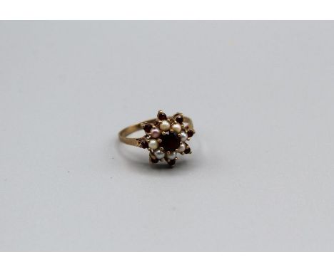 A garnet and split pearl set starburst cluster ring in 9ct gold, size T.&nbsp;Gross weight approximately&nbsp; 3.2gm