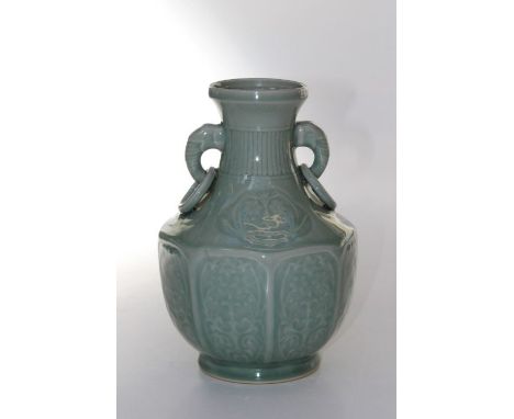 A 20th century Chinese celadon glaze vase of baluster hexagonal form, with twin elephant mask ring handles, on circular foot.