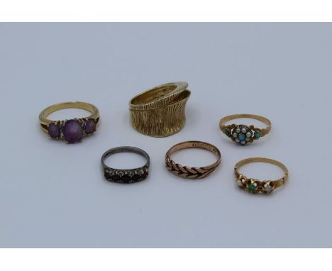 A collection of 9ct gold, yellow metal and 925 rings, featuring a 9ct gold keeper ring, 1.7 grams approximately , size L, a y