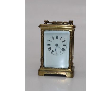 An early 20th century brass, five glass carriage clock with pillared case, enamel Roman dial. 14cm 9 handle up), currently wo