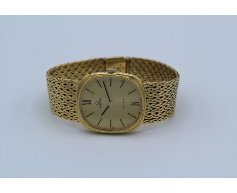A 1970's Omega De Ville 18 carat gold wristwatch, the matching dial having Roman and baton numerals and a fine mesh link band