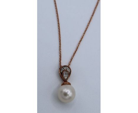 Cultured pearl and diamond inverted pear-shape bale pendant and chain. Featuring an 8mm cultured pearl and an estimated 0.08 