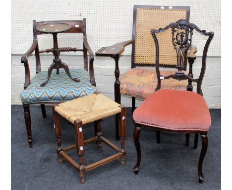 An Edwardian cane back library armchair, a George III mahogany carver chair, an Edwardian salon chair, rush seat stool and a 