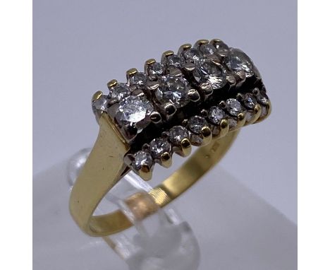 Ladies 18ct Gold and Diamond ring, with four large diamond as a centre piece framed with 16 small diamonds. (Marked 18ct) siz