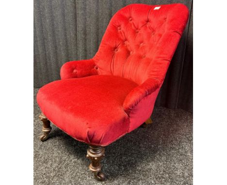 19th century bedroom chair in a red button back upholstery raised on carved turned legs ending in castor feet