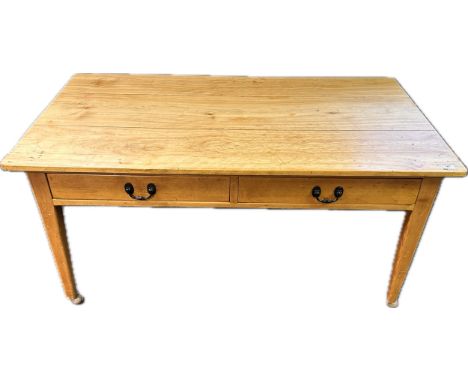 Farmhouse pine kitchen table/work bench, with two frieze drawers raised on squared tapered legs ending in wheeled feet.