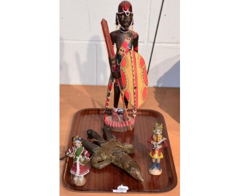 A pair of Indian bead work figures, an African carved figure and a three dagger scabbard made from a monitor lizard torso, ci
