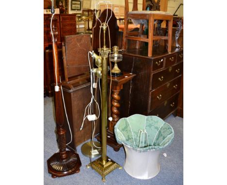 A brass Corinthian columnar standard lamp; mahogany standard lamp; an uplighter; and a Victorian oil lamp (4)