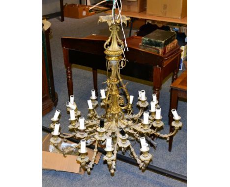 ~ A gilt metal scroll and leaf cast twenty three light candelabra (in need of refurbishment)