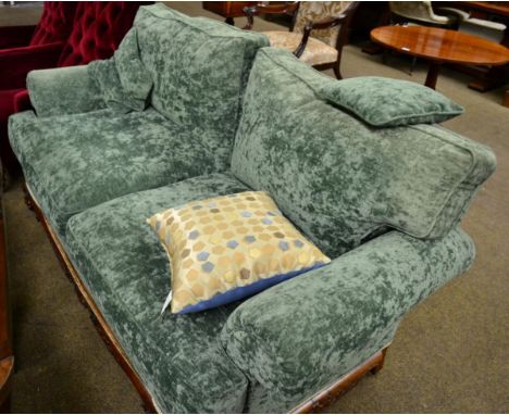 Two seater sofa with carved mahogany frame on ball and claw feet 