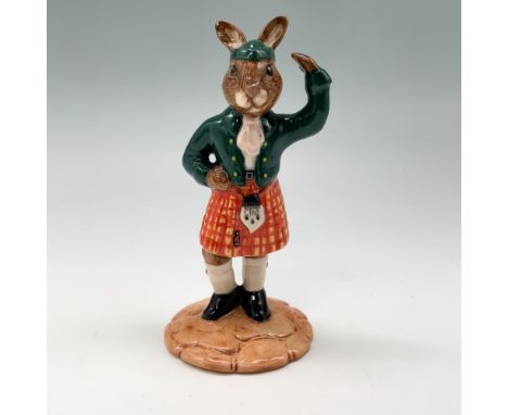 This charming Royal Doulton Bunnykins figurine, titled "Scotsman" (DB180), depicts a delightful bunny dressed in traditional 