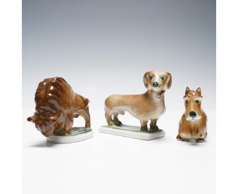 Group of three hand-painted porcelain animal figurines by Zsolnay Pecs of Hungary, including one bison and two dogs. Each fig