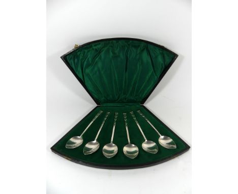 A cased set of six George V hallmarked silver spoonsEach having cast Art Deco decoration to handles above heart shaped bowls 