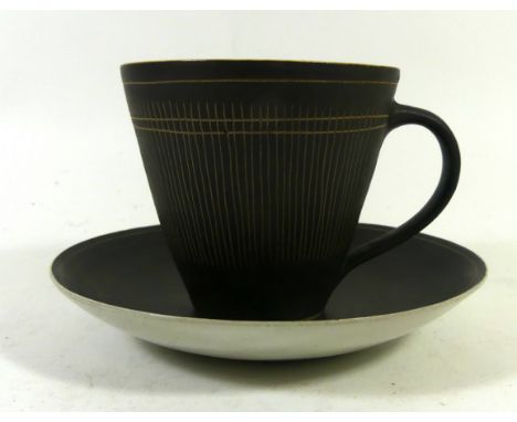 Dame Lucie Rie D.B.E (1902-1995) cup and saucerHaving sgraffito linear decoration, mark to base, height 8cmCONDITION REPORT:M
