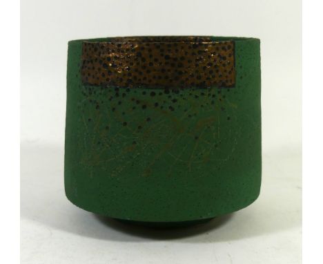 Robin Welch (b.1936-) An early Studio Pottery tea bowl having black dots on a gold rim and jade body, impressed seal mark to 