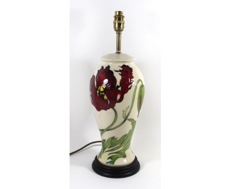 A modern Moorcroft pottery lampOf baluster form, decorated with red floral motifs on an ivory ground, height excluding fittin