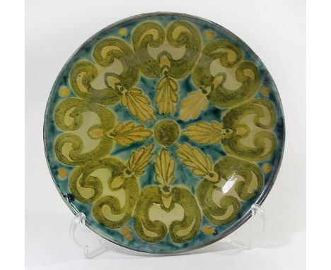 An Arts & Crafts Della Robbia, Birkenhead footed plateOf circular form, having stylised floral decoration, designed by Arthur