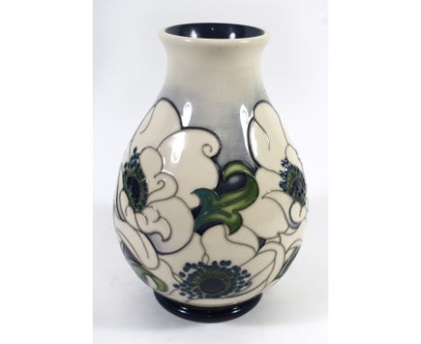 A modern Moorcroft trial vaseOf baluster form, decorated with stylised floral motifs on a grey/blue ground, impressed factory