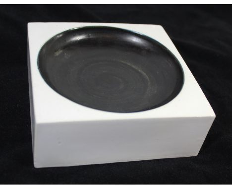 A Troika Cornwall ceramic dishHaving a black glazed centre inside a white glazed border, probably made for Heal's London, sig