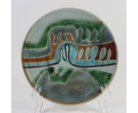 A Poole Pottery Studio Delphis wall plateOf circular form, having stylised designs on a light green ground, blue factory mark