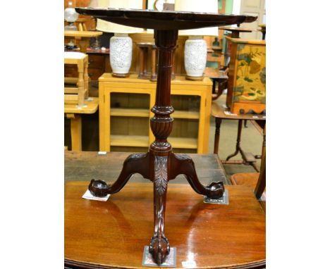 A 19th century mahogany tilt top tripod table, the shaped circular dish top raised on down swept legs terminating in ball and